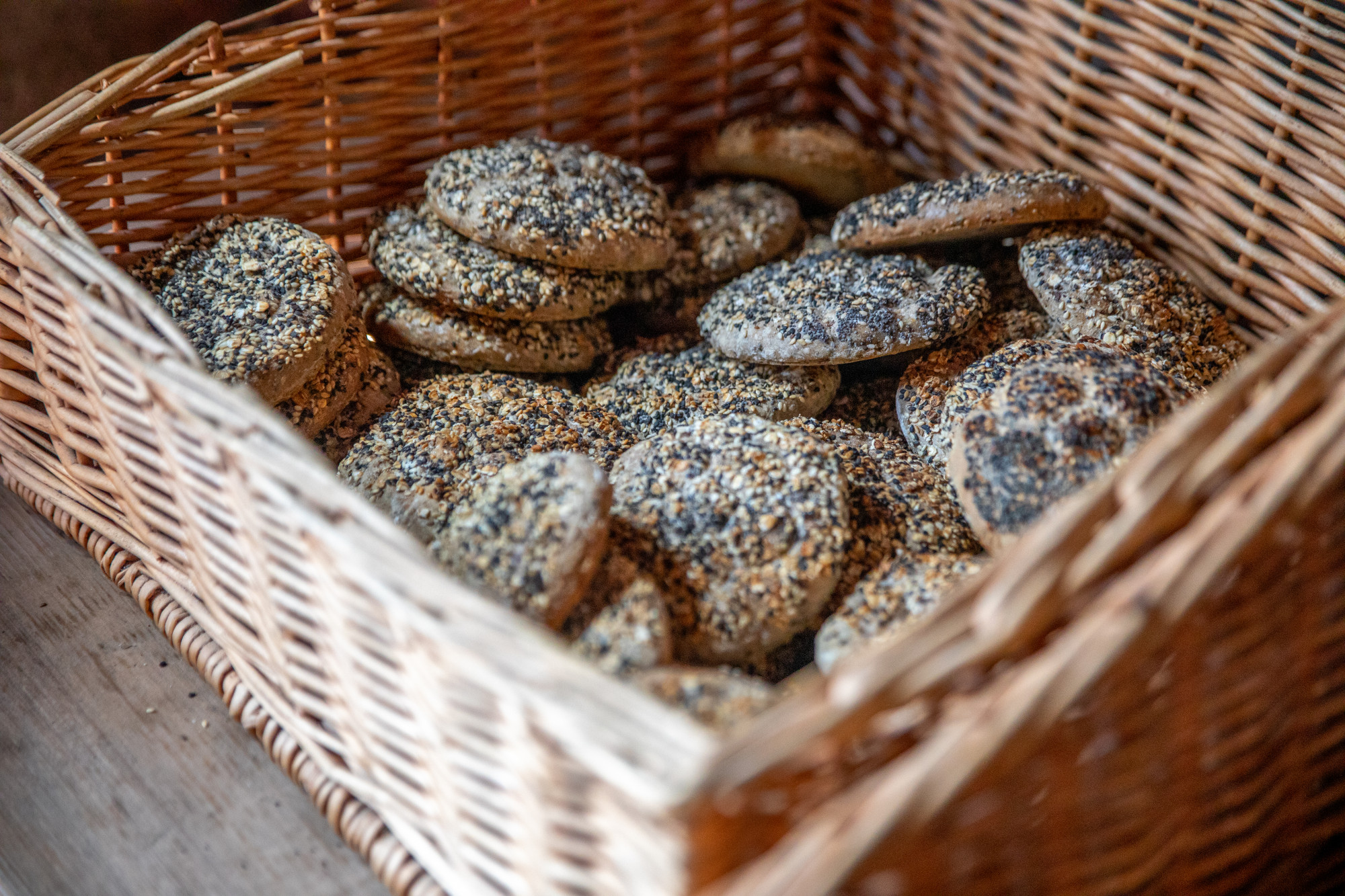 Mit K&ouml;rnern best&uuml;ckte Br&ouml;tchen in einem Weidenkorb